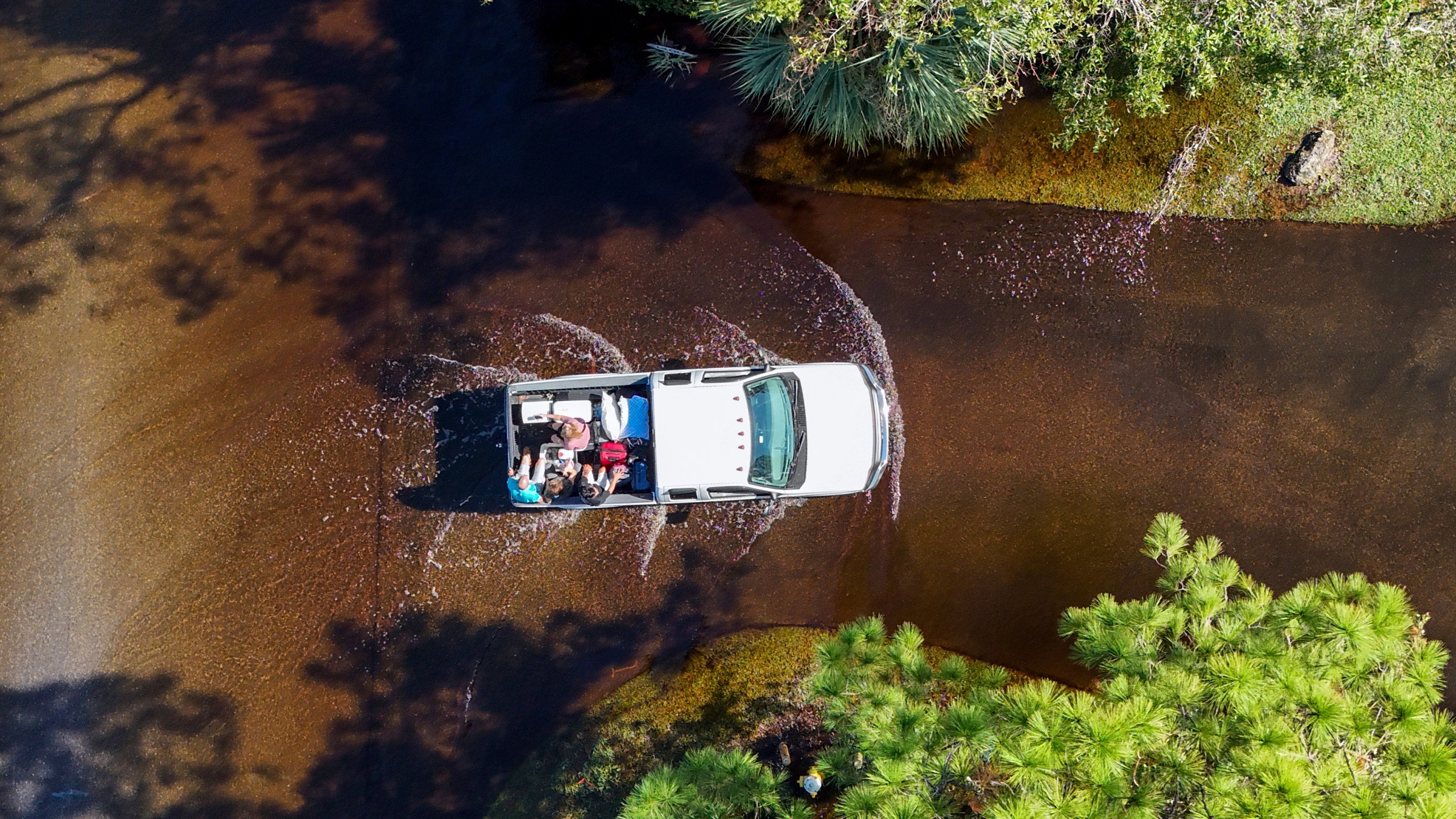 Two couples who evacuated get a ride back to their home through flooding after Hurricane Milton hit the region, Thursday, Oct. 10, 2024, in Palm Harbor, Fla. (AP Photo/Mike Carlson)