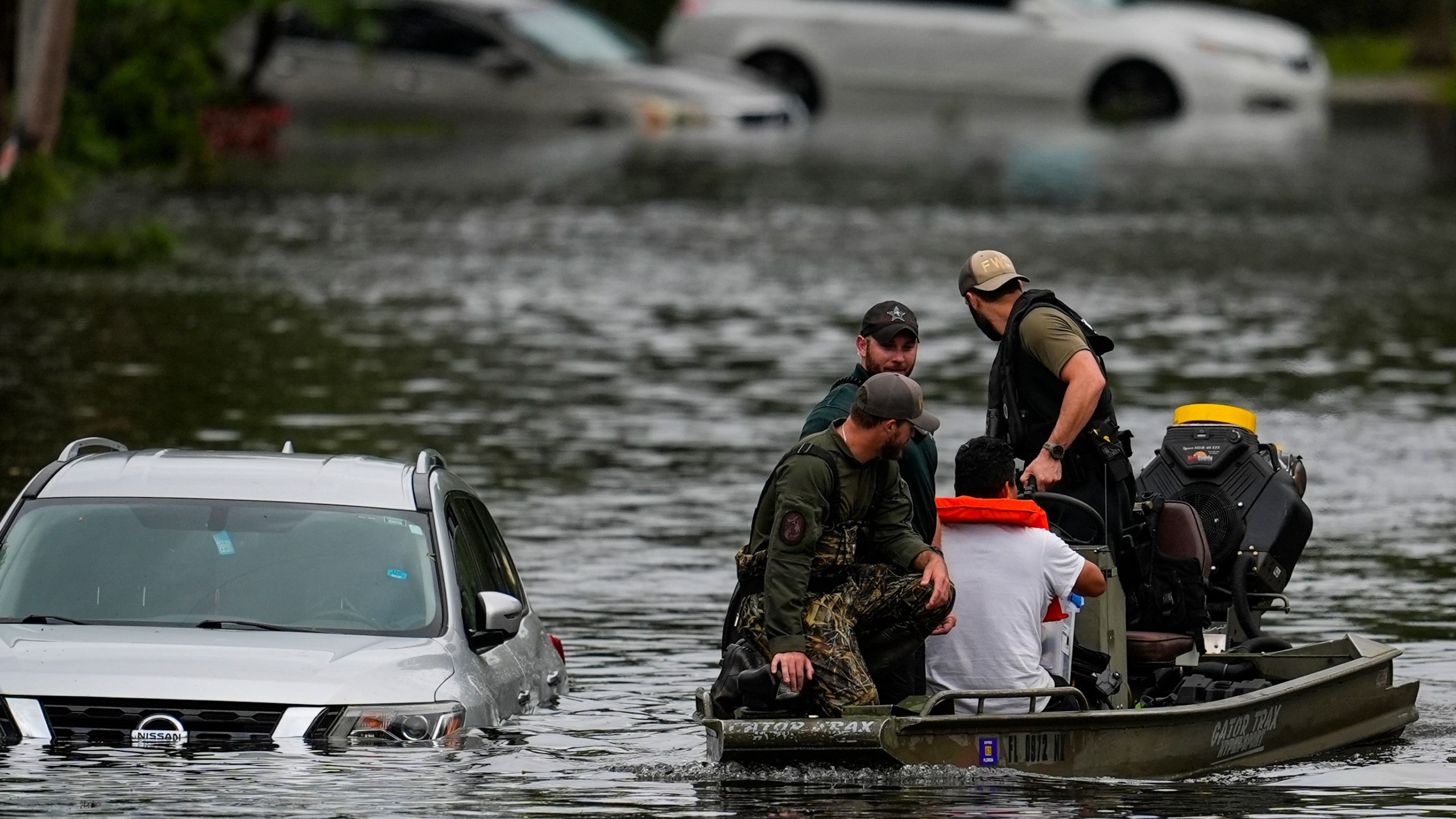 People are rescued from an apartment complex in the aftermath of Hurricane Milton, Thursday, Oct. 10, 2024, in Clearwater, Fla. (AP Photo/Mike Stewart)