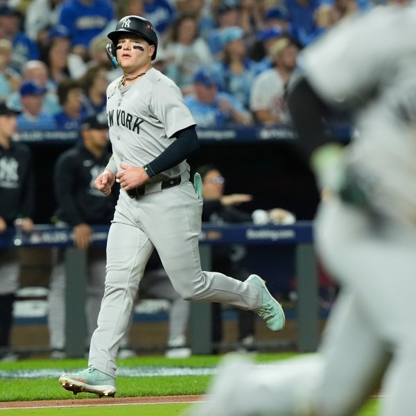 New York Yankees' Alex Verdugo scores during the fifth inning in Game 4 of an American League Division baseball playoff series against the Kansas City Royals Thursday, Oct. 10, 2024, in Kansas City, Mo. (AP Photo/Charlie Riedel)