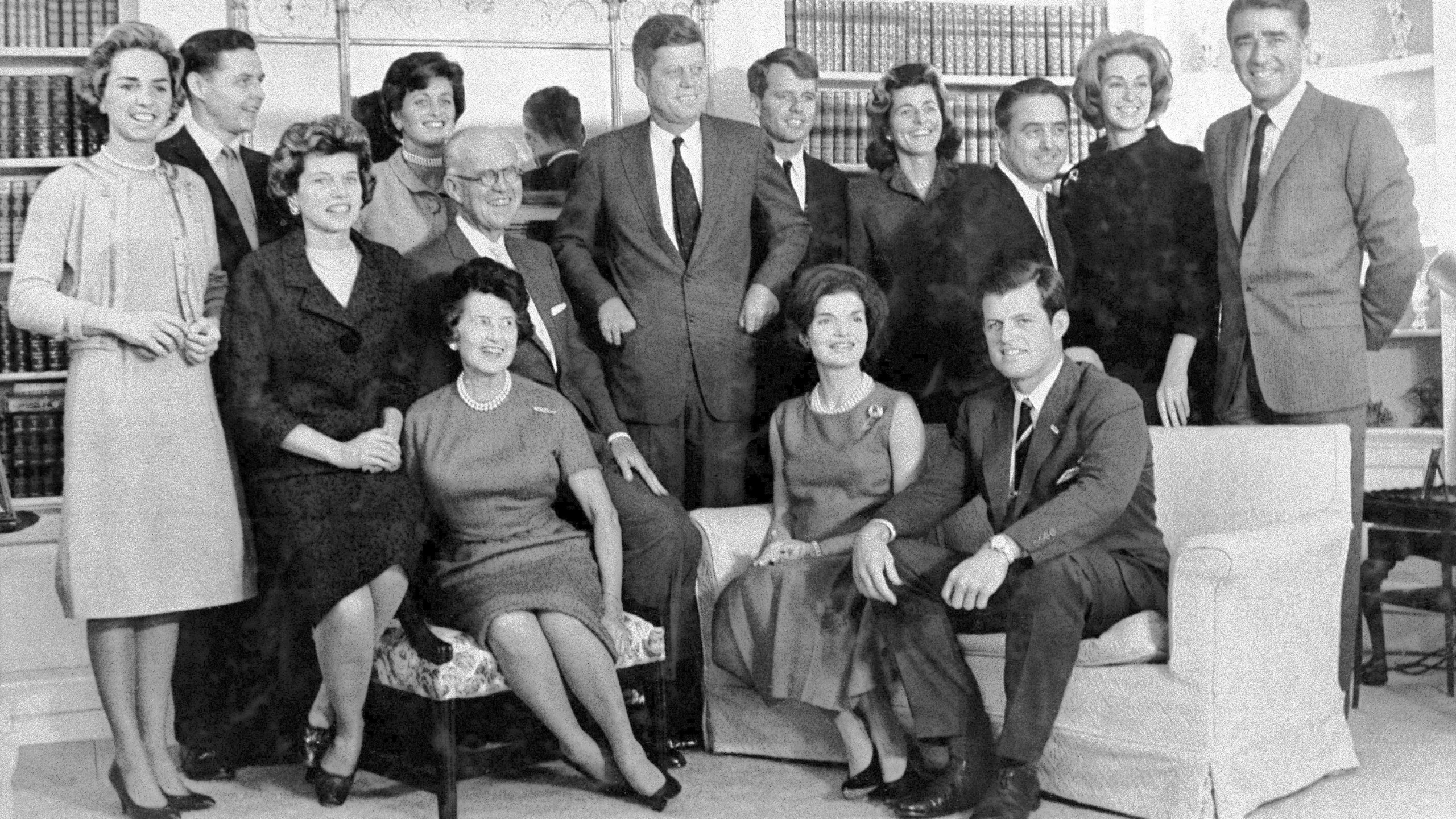 FILE - Then President-elect John F. Kennedy, standing at center, is surrounded by members of his family in the home of his parents in December 1960, in Hyannis Port, Mass. Standing, Ethel Kennedy, from left, wife of Robert Kennedy, Steven Smith and wife Jean Kennedy Smith, Robert Kennedy, Patricia Kennedy Lawford, Sargent Shriver, Joan Kennedy, wife of Edward Kennedy, and Peter Lawford, and in foreground, Eunice Kennedy Shriver, from left, Joseph P. Kennedy and wife Rose Kennedy, seated in front, Jacqueline Kennedy, and Edward Kennedy. (AP Photo, File)