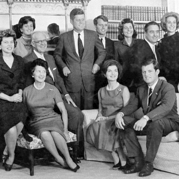 FILE - Then President-elect John F. Kennedy, standing at center, is surrounded by members of his family in the home of his parents in December 1960, in Hyannis Port, Mass. Standing, Ethel Kennedy, from left, wife of Robert Kennedy, Steven Smith and wife Jean Kennedy Smith, Robert Kennedy, Patricia Kennedy Lawford, Sargent Shriver, Joan Kennedy, wife of Edward Kennedy, and Peter Lawford, and in foreground, Eunice Kennedy Shriver, from left, Joseph P. Kennedy and wife Rose Kennedy, seated in front, Jacqueline Kennedy, and Edward Kennedy. (AP Photo, File)