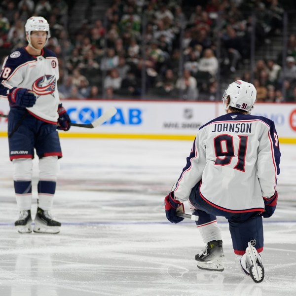 Columbus Blue Jackets center Kent Johnson (91) celebrates toward teammate defenseman Damon Severson, left, after scoring during the second period of an NHL hockey game against the Minnesota Wild, Thursday, Oct. 10, 2024, in St. Paul, Minn. (AP Photo/Abbie Parr)