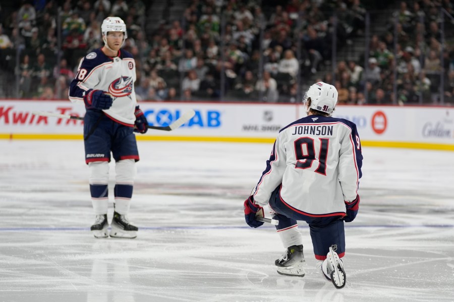 Columbus Blue Jackets center Kent Johnson (91) celebrates toward teammate defenseman Damon Severson, left, after scoring during the second period of an NHL hockey game against the Minnesota Wild, Thursday, Oct. 10, 2024, in St. Paul, Minn. (AP Photo/Abbie Parr)