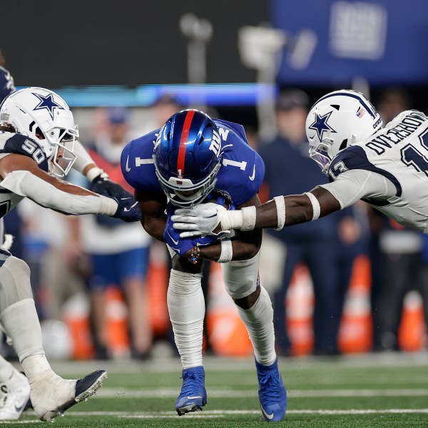 New York Giants wide receiver Malik Nabers (1) carries the ball against Dallas Cowboys linebacker DeMarvion Overshown (13) and linebacker Eric Kendricks (50) during the fourth quarter of an NFL football game, Thursday, Sept. 26, 2024, in East Rutherford, N.J. (AP Photo/Adam Hunger)