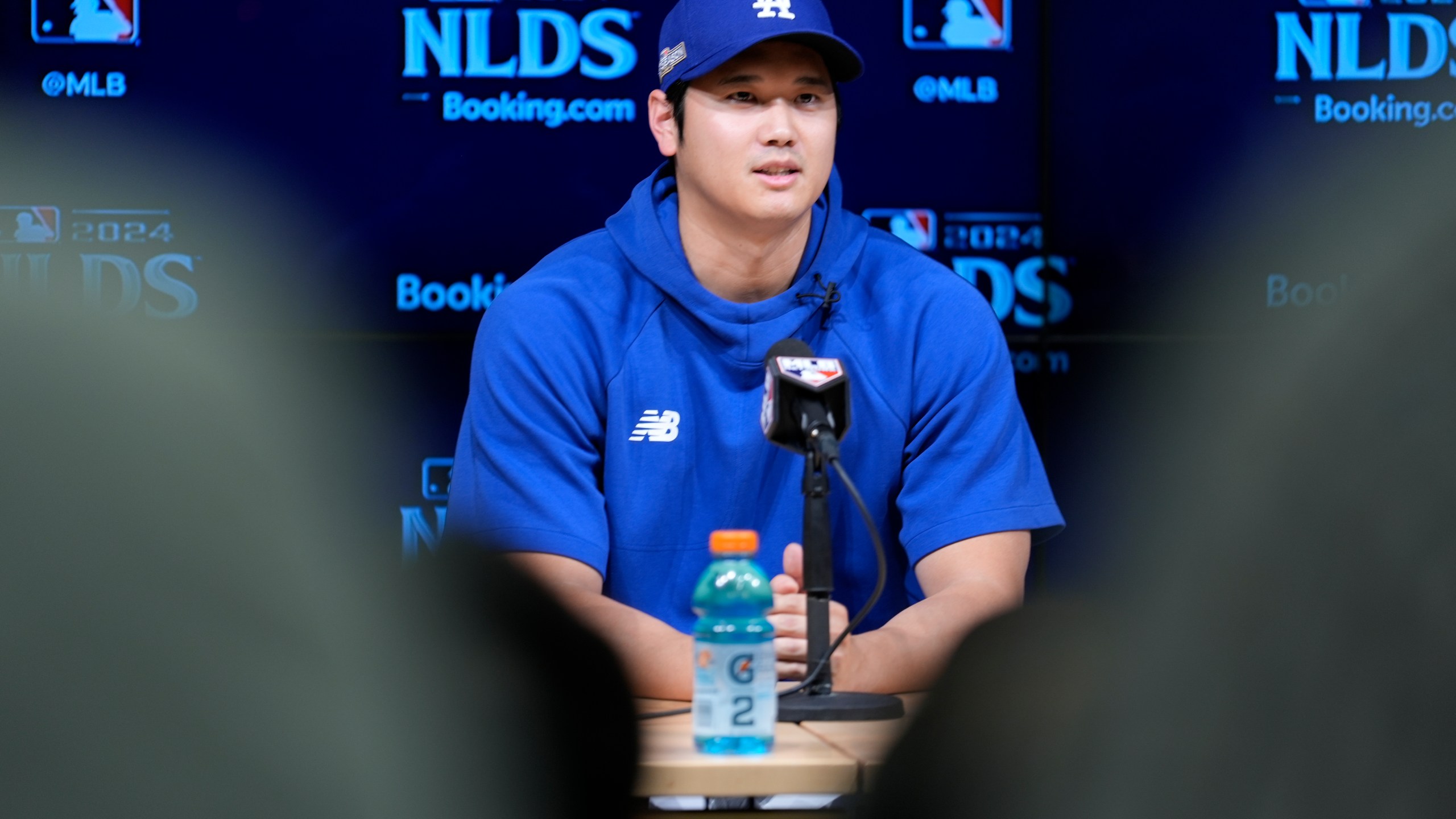 Los Angeles Dodgers' Shohei Ohtani fields questions ahead of Game 5 of a baseball National League Division Series against the San Diego Padres, Thursday, Oct. 10, 2024, in Los Angeles. (AP Photo/Ashley Landis)