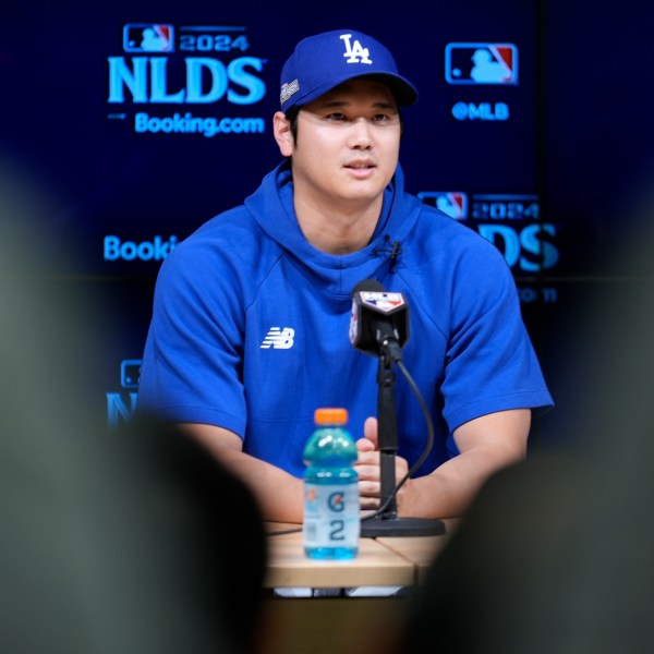 Los Angeles Dodgers' Shohei Ohtani fields questions ahead of Game 5 of a baseball National League Division Series against the San Diego Padres, Thursday, Oct. 10, 2024, in Los Angeles. (AP Photo/Ashley Landis)