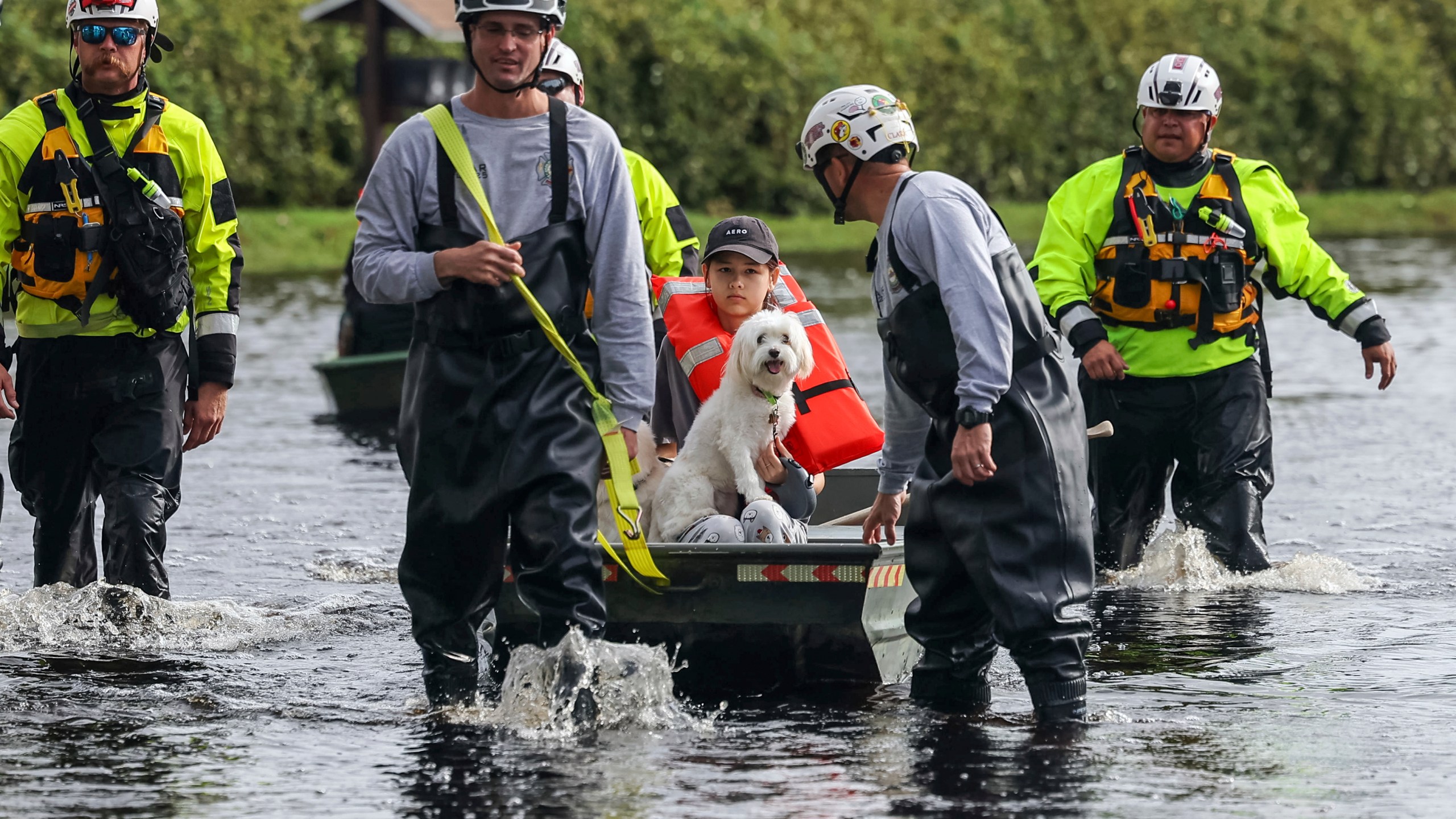 Amy Bishop is evacuated from her home by Pasco County Fire and Rescue and Sheriff's Office teams as waters rise in her neighborhood after Hurricane Milton caused the Anclote River to flood, Friday, Oct. 11, 2024, in New Port Richey, Fla. (AP Photo/Mike Carlson)