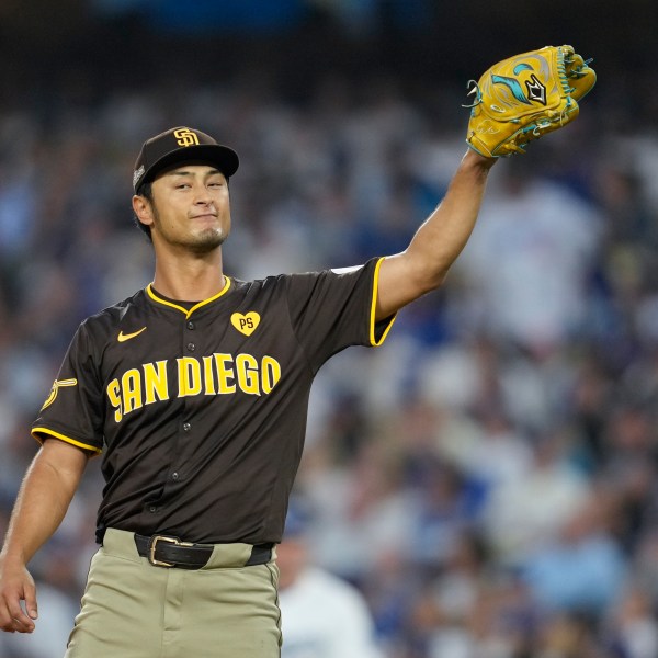 San Diego Padres pitcher Yu Darvish gets a ball back as he pitches during the fifth inning in Game 5 of a baseball NL Division Series against the Los Angeles Dodgers, Friday, Oct. 11, 2024, in Los Angeles. (AP Photo/Ashley Landis)