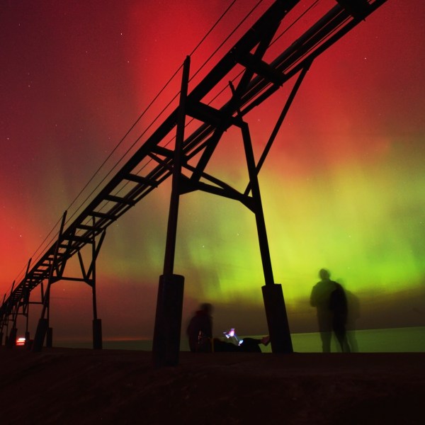 An aurora borealis, also known as the northern lights, lights up the night sky off Lake Michigan and the St. Joseph Lighthouse, Thursday, Oct. 10, 2024, in St. Joseph, Mich. (Don Campbell/The Herald-Palladium via AP)