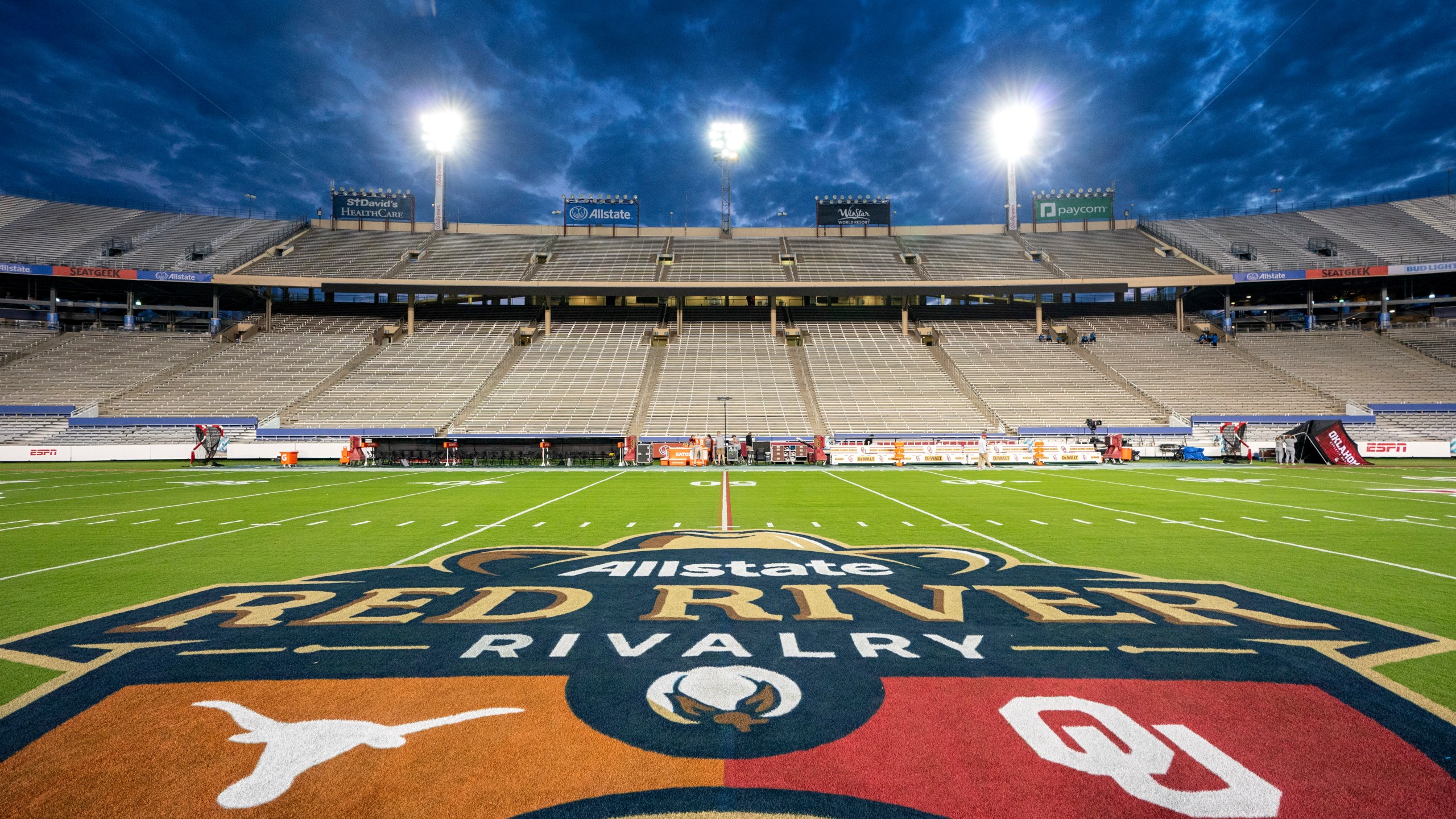 FILE - The logos of Texas and Oklahoma are painted at midfield before an NCAA college football game at the Cotton Bowl, Saturday, Oct. 7, 2023, in Dallas. (AP Photo/Jeffrey McWhorter, File)