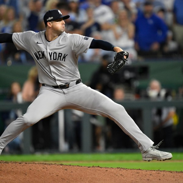 New York Yankees relief pitcher Clay Holmes throws during the eighth inning in Game 4 of an American League Division baseball playoff series against the Kansas City Royals Thursday, Oct. 10, 2024, in Kansas City, Mo. (AP Photo/Reed Hoffmann)