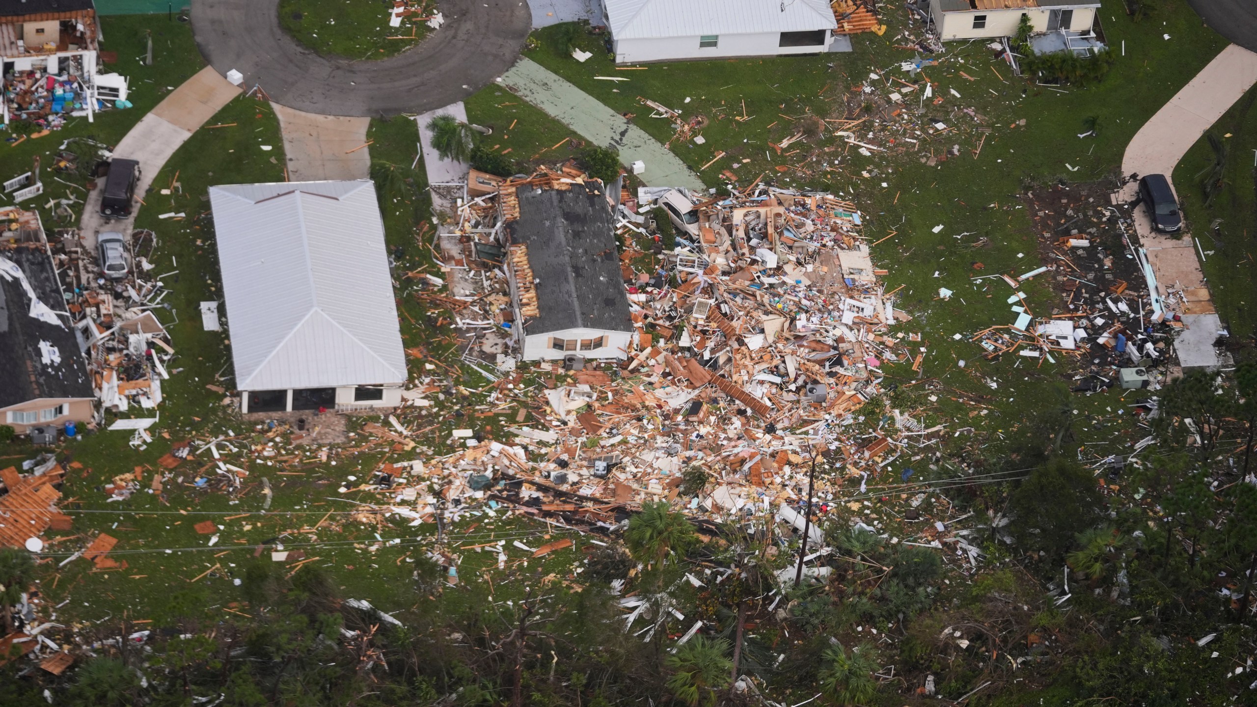 Neighborhoods destroyed by tornadoes are seen in this aerial photo in the aftermath of Hurricane Milton, Thursday, Oct. 10, 2024, in Fort Pierce, Fla. (AP Photo/Gerald Herbert)