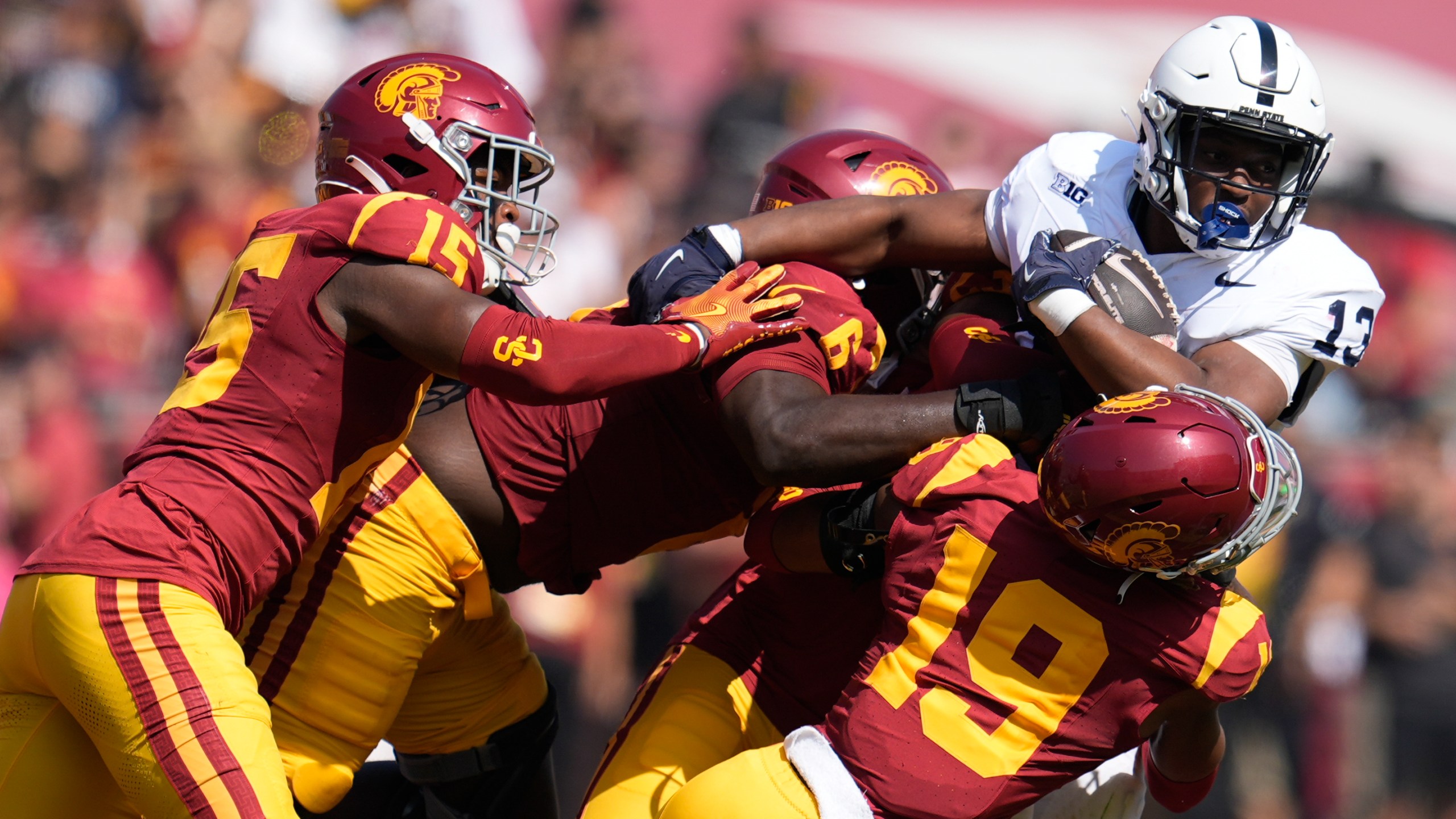 Penn State running back Kaytron Allen (13) is tackled by Southern California cornerback John Humphrey (19), defensive end Anthony Lucas (6) and safety Anthony Beavers Jr. (15) during the first half of an NCAA college football game Saturday, Oct. 12, 2024, in Los Angeles. (AP Photo/Marcio Jose Sanchez)