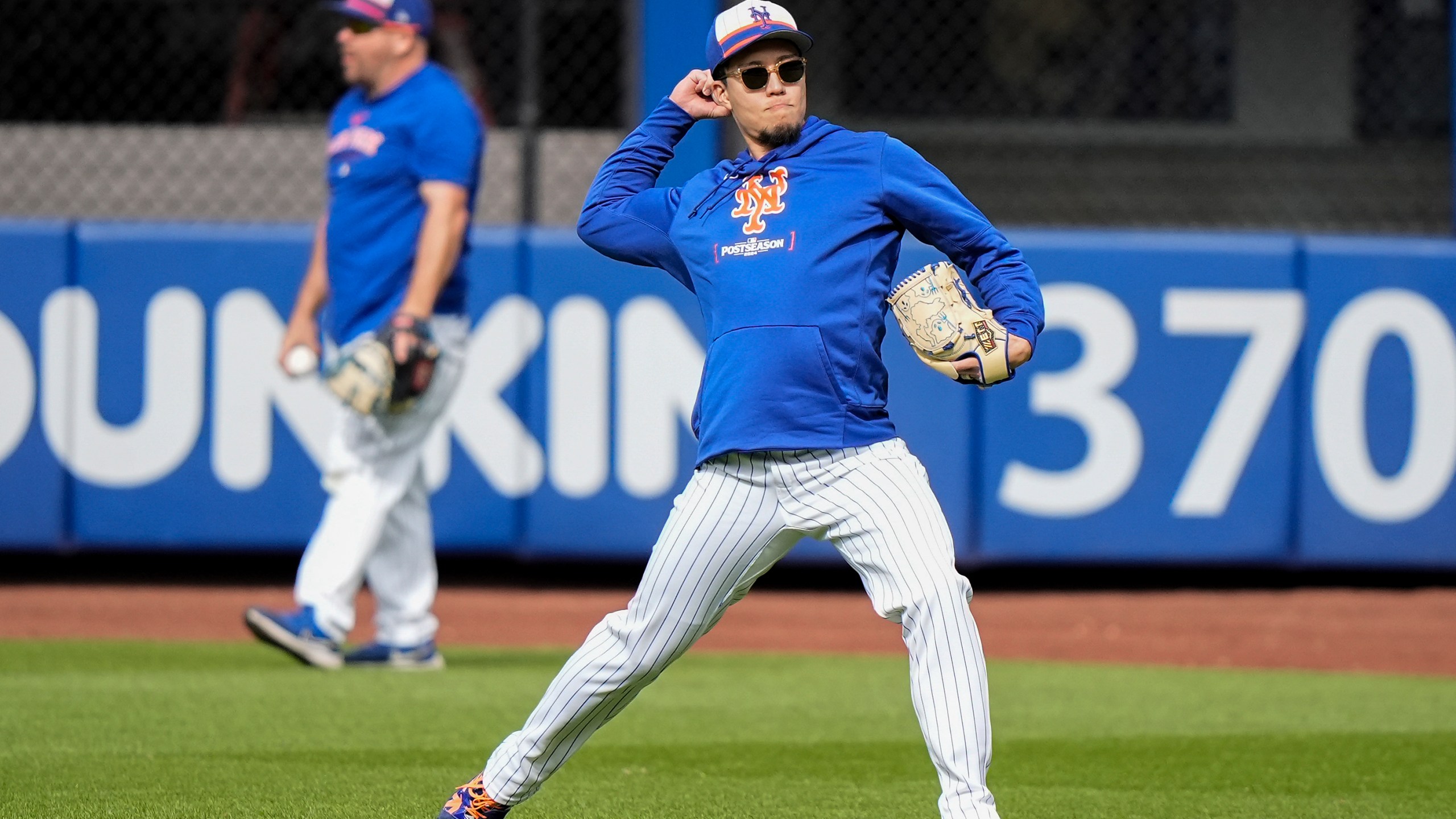 New York Mets pitcher Kodai Senga shags balls in the outfield before Game 3 of the National League baseball playoff series against the Philadelphia Phillies, Tuesday, Oct. 8, 2024, in New York. (AP Photo/Frank Franklin II)