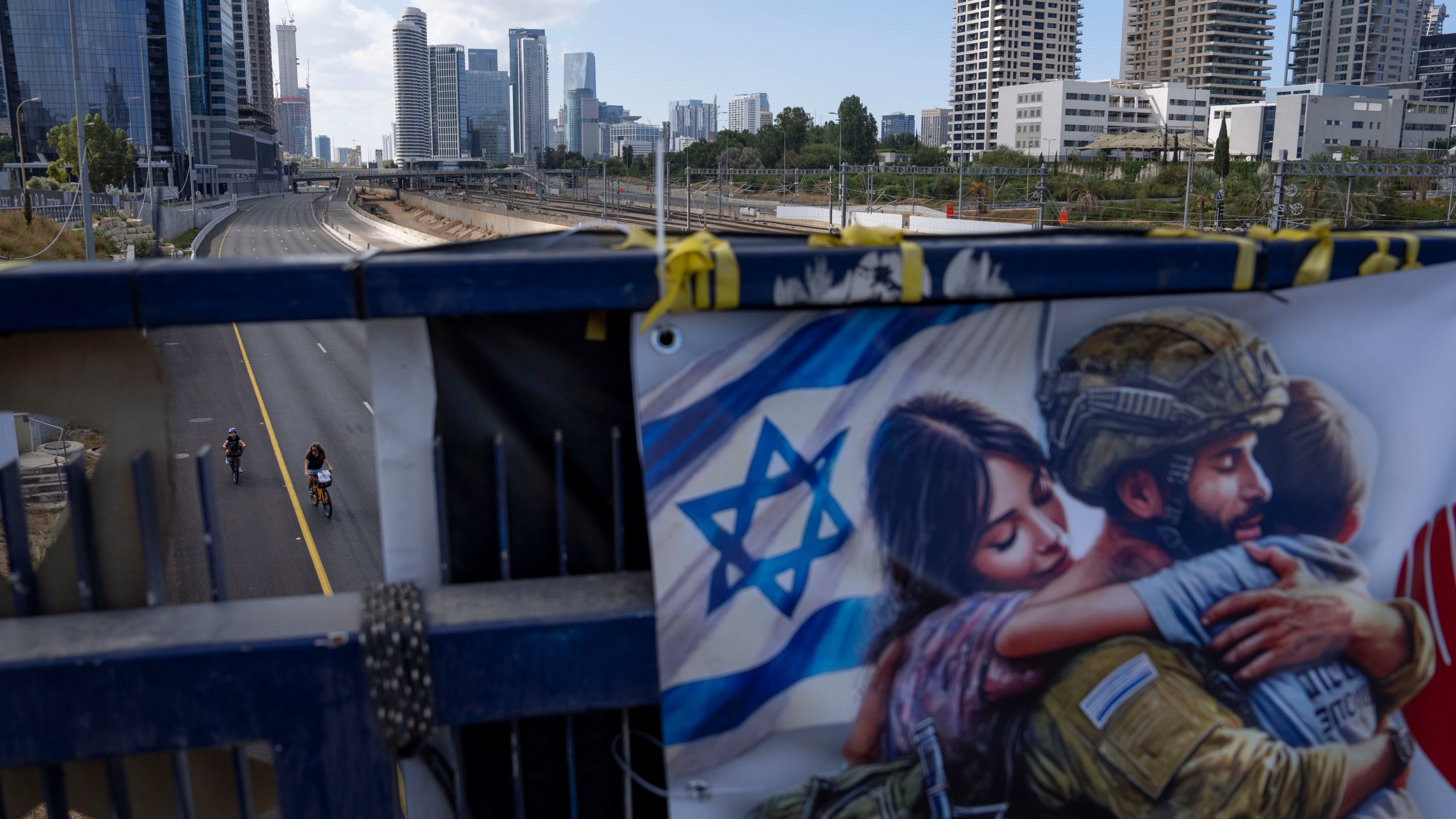 Cyclists ride on a car-free highway during the Jewish holiday of Yom Kippur in Tel Aviv, Israel, on Saturday, Oct. 12, 2024. (AP Photo/Oded Balilty)