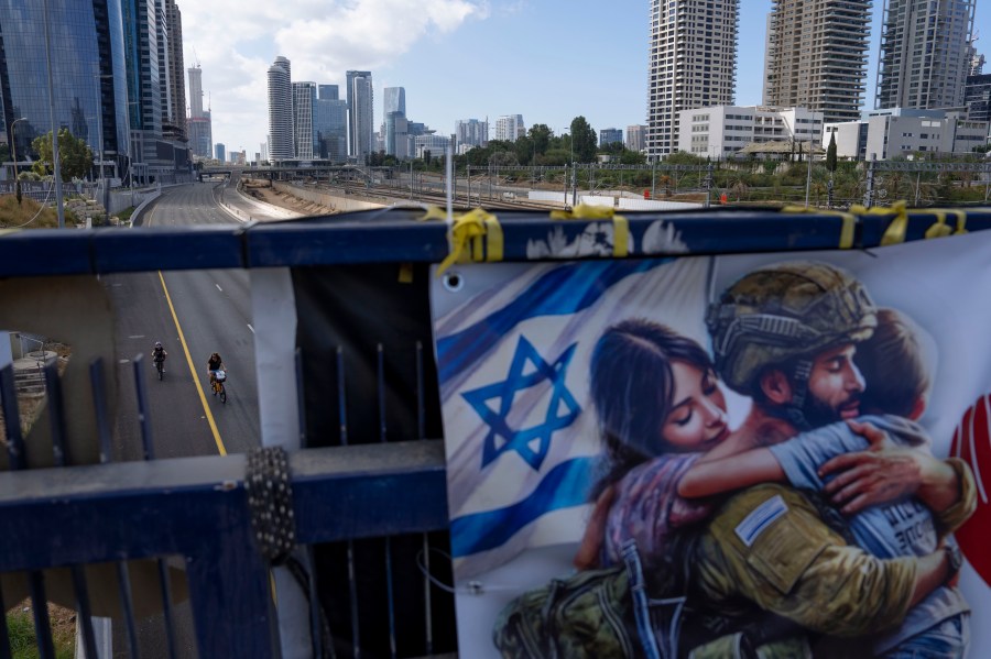 Cyclists ride on a car-free highway during the Jewish holiday of Yom Kippur in Tel Aviv, Israel, on Saturday, Oct. 12, 2024. (AP Photo/Oded Balilty)