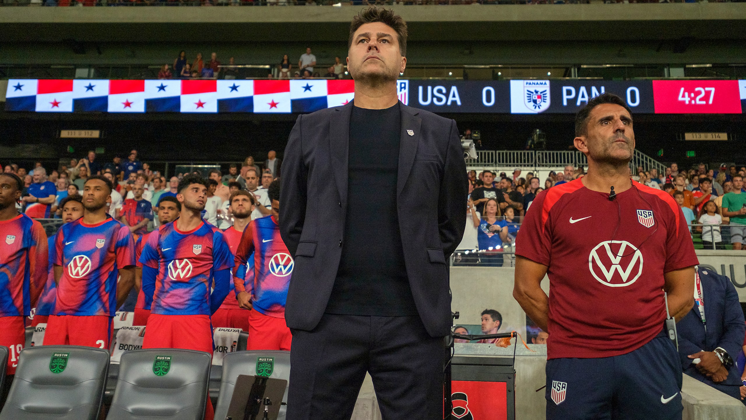 United States head coach Mauricio Pochettino, front left, and first assistant coach Jesus Perez, right, stand for the national anthem before an international friendly soccer match against Panama, Saturday, Oct. 12, 2024, in Austin, Texas. (AP Photo/Rodolfo Gonzalez)