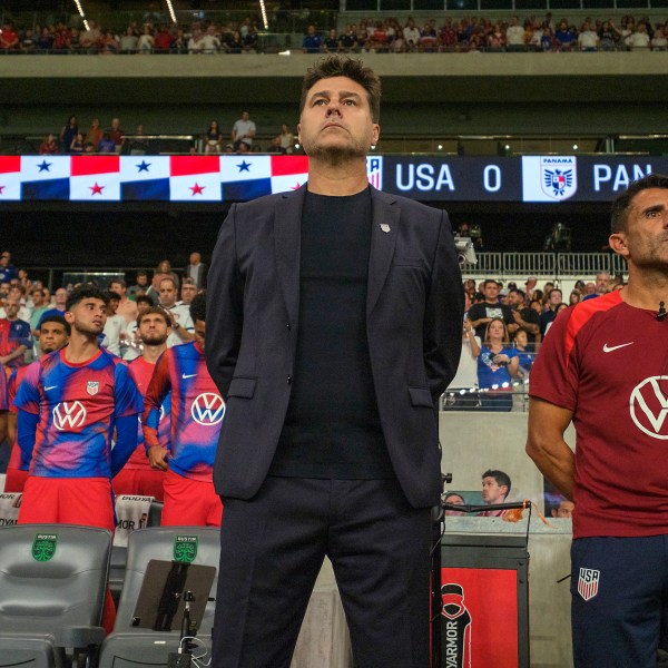 United States head coach Mauricio Pochettino, front left, and first assistant coach Jesus Perez, right, stand for the national anthem before an international friendly soccer match against Panama, Saturday, Oct. 12, 2024, in Austin, Texas. (AP Photo/Rodolfo Gonzalez)