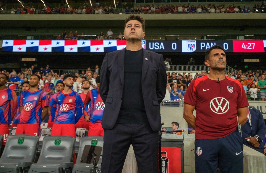 United States head coach Mauricio Pochettino, front left, and first assistant coach Jesus Perez, right, stand for the national anthem before an international friendly soccer match against Panama, Saturday, Oct. 12, 2024, in Austin, Texas. (AP Photo/Rodolfo Gonzalez)