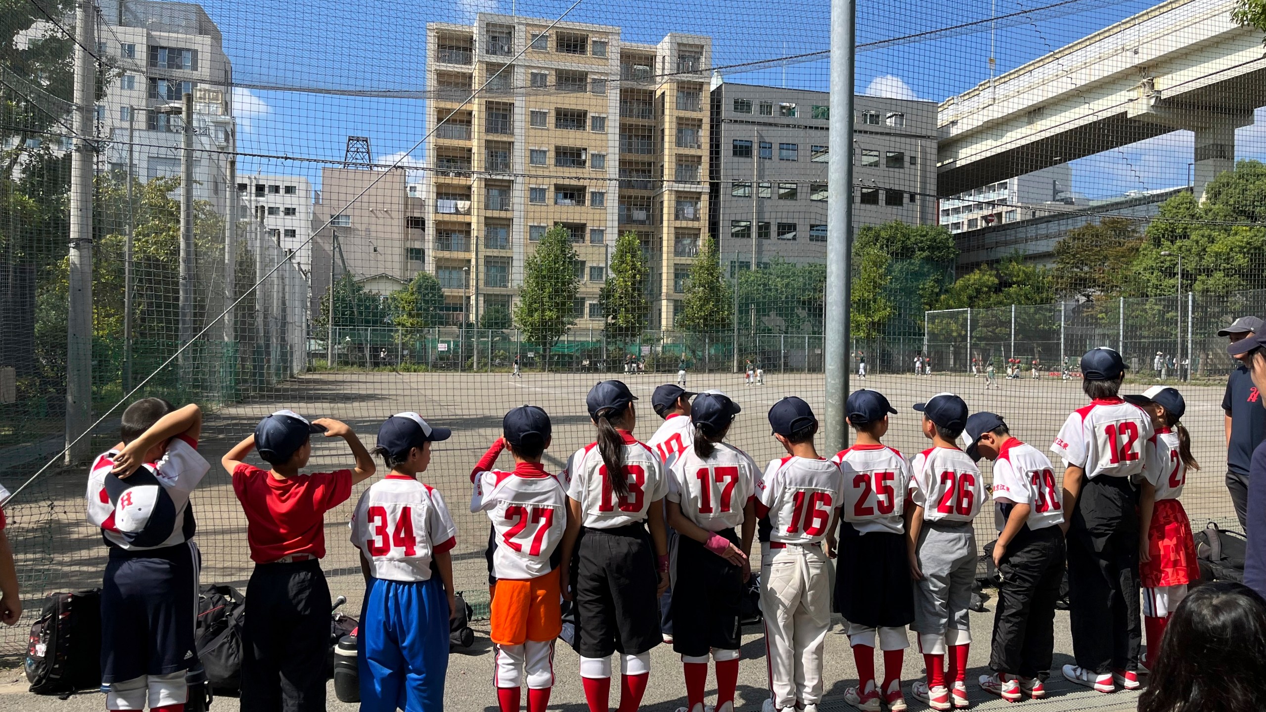 The Fukagawa Hawks youth baseball team stand in line after their practice Sunday, Oct. 13, 2024, in Tokyo, Japan. (AP Photo/Stephen Wade)