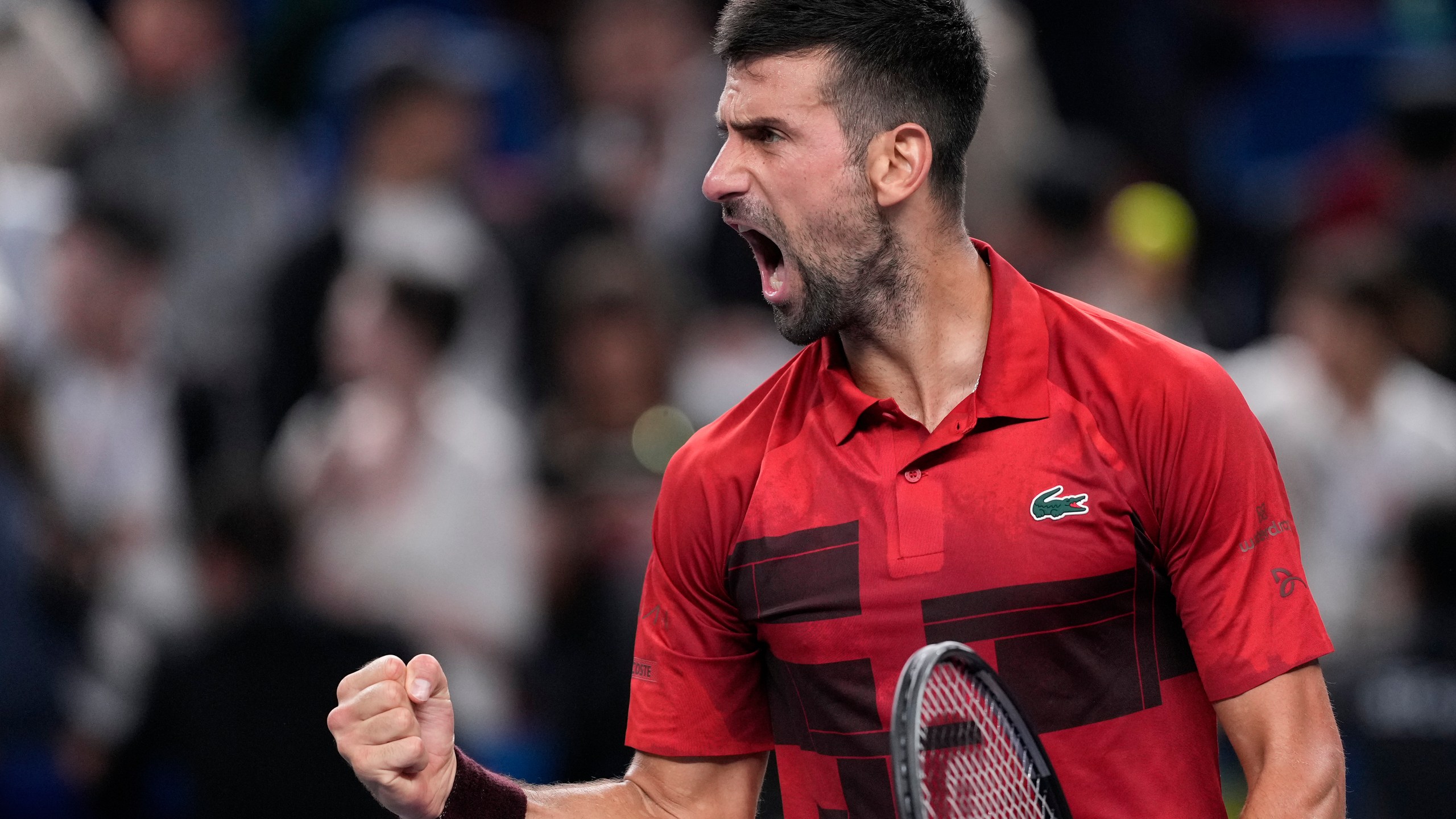 Novak Djokovic of Serbia reacts after defeating Taylor Fritz of the United States in the men's singles semifinals match of the Shanghai Masters tennis tournament at Qizhong Forest Sports City Tennis Center in Shanghai, China, Saturday, Oct. 12, 2024. (AP Photo/Andy Wong)