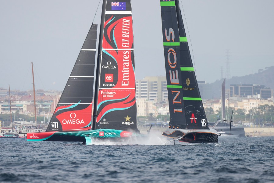 Ineos Britannia and Emirates Team New Zealand race during the Louis Vuitton 37th America's Cup Day 2 race in Barcelona, Spain, Sunday, Oct. 13, 2024. (AP Photo/Bernat Armangue)