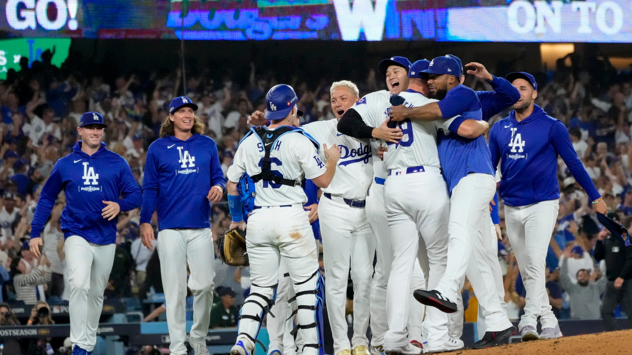 The Los Angeles Dodgers celebrate off the mound after defeating the San Diego Padres in Game 5 of a baseball NL Division Series Friday, Oct. 11, 2024, in Los Angeles. (AP Photo/Mark J. Terrill)