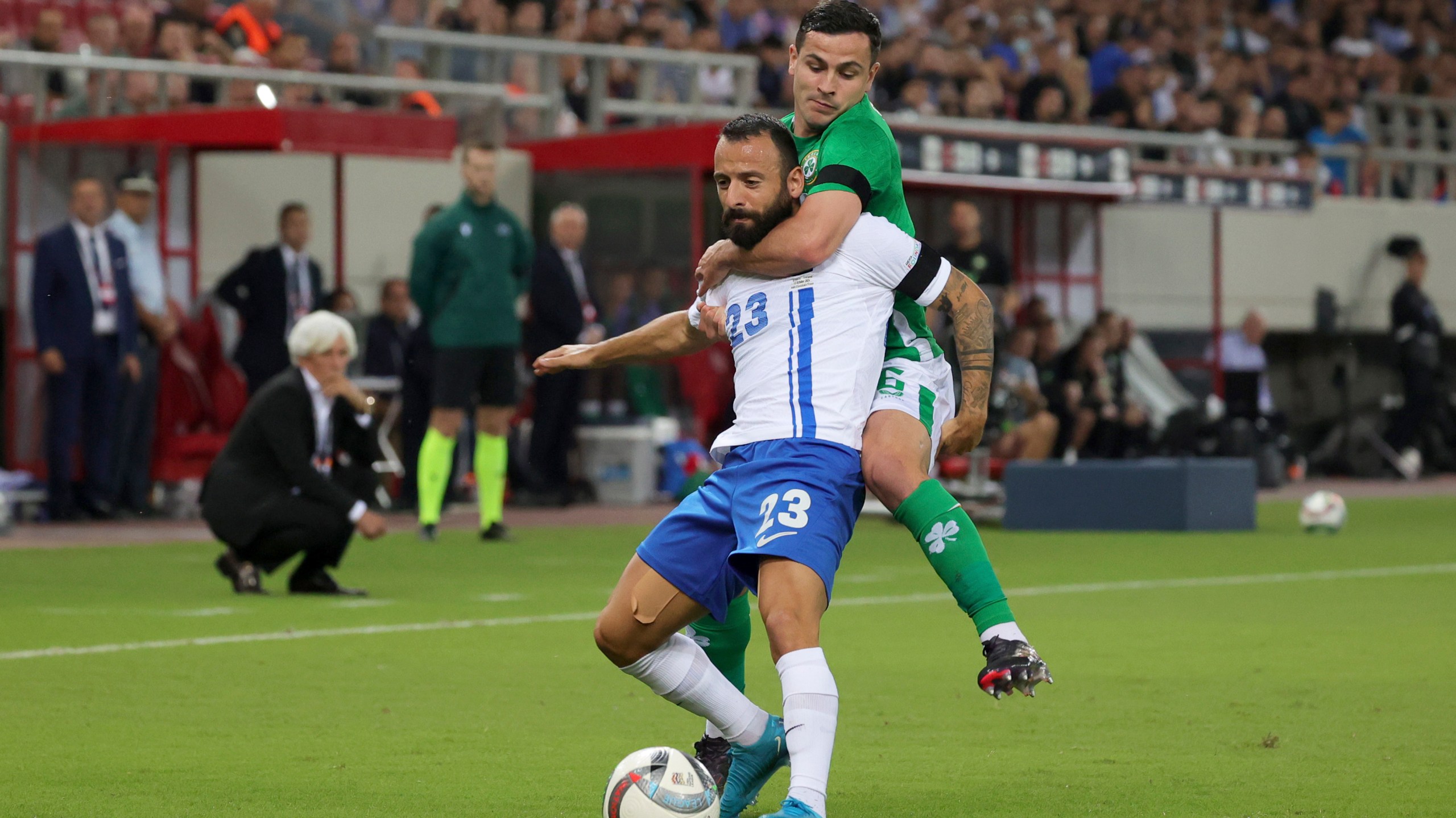 Ireland's Josh Cullen fights for the ball with Greece's Manolis Siopis, left, during a Nations League soccer match between Greece and Ireland at the Georgios Karaiskakis Stadium in Piraeus port, near Athens, Sunday, Oct. 13, 2024. (AP Photo/Yorgos Karahalis)