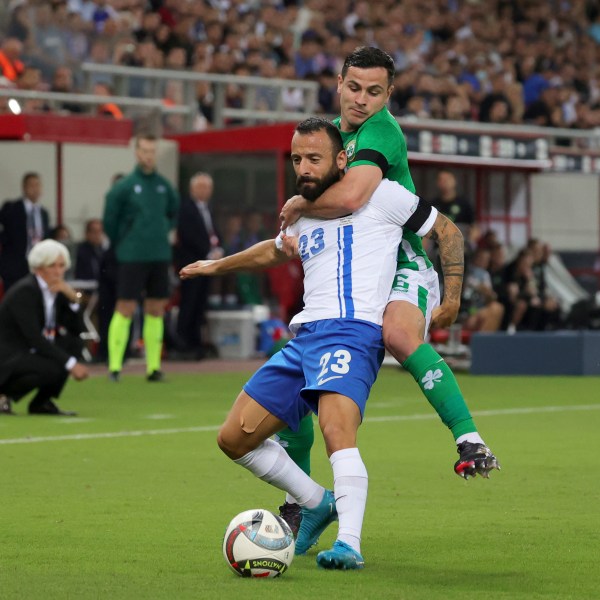 Ireland's Josh Cullen fights for the ball with Greece's Manolis Siopis, left, during a Nations League soccer match between Greece and Ireland at the Georgios Karaiskakis Stadium in Piraeus port, near Athens, Sunday, Oct. 13, 2024. (AP Photo/Yorgos Karahalis)