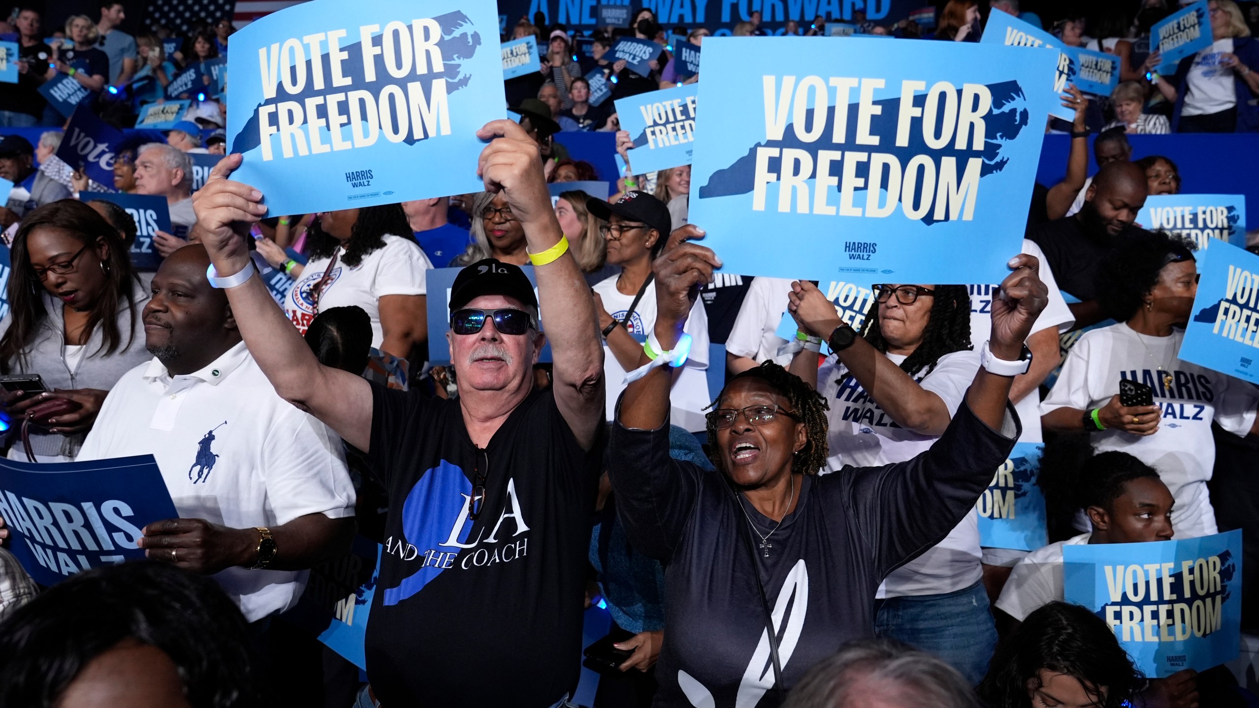 Attendees hold up signs before Democratic presidential nominee Vice President Kamala Harris arrives to speak at a campaign rally at East Carolina University in Greenville, N.C., Sunday, Oct. 12, 2024. (AP Photo/Susan Walsh)