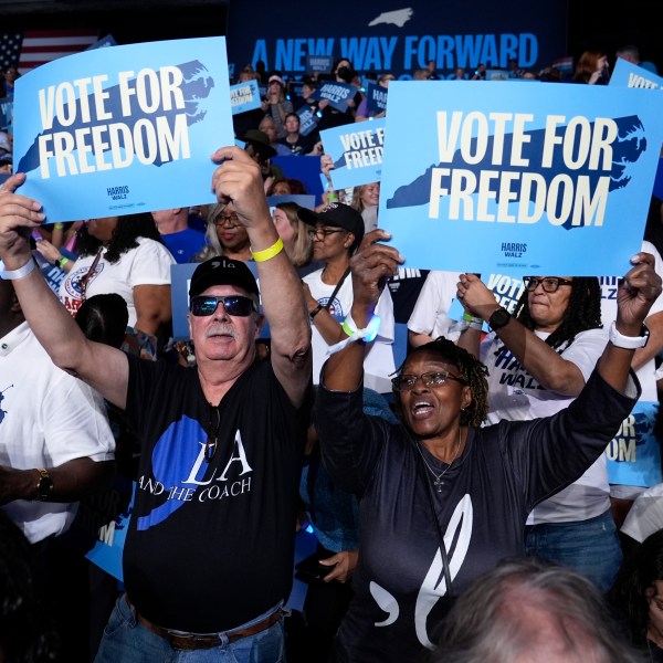 Attendees hold up signs before Democratic presidential nominee Vice President Kamala Harris arrives to speak at a campaign rally at East Carolina University in Greenville, N.C., Sunday, Oct. 12, 2024. (AP Photo/Susan Walsh)