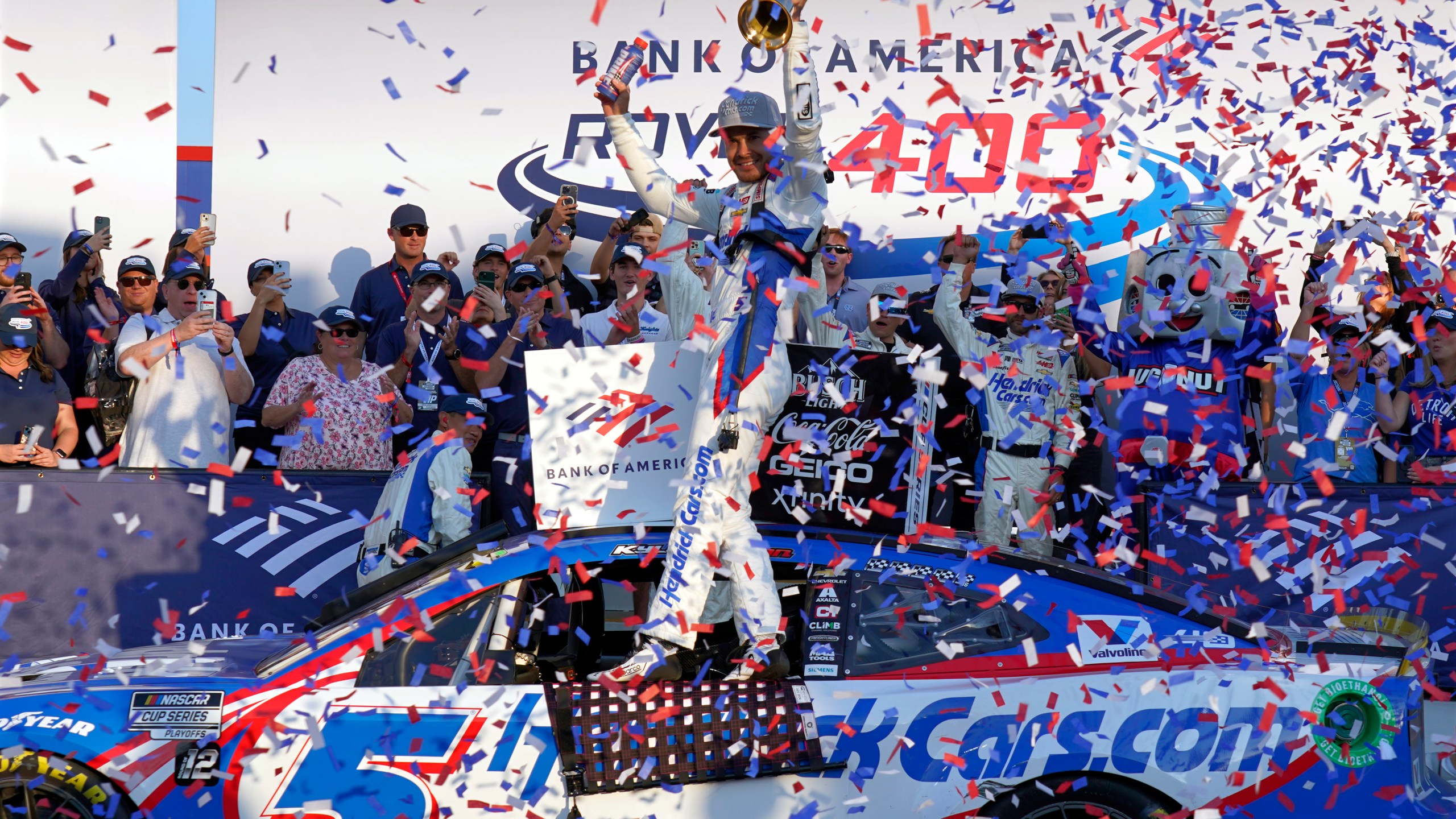 Kyle Larson, center, celebrates in Victory Lane after winning a NASCAR Cup Series auto race at Charlotte Motor Speedway in Concord, N.C., Sunday, Oct. 13, 2024. (AP Photo/Chuck Burton)