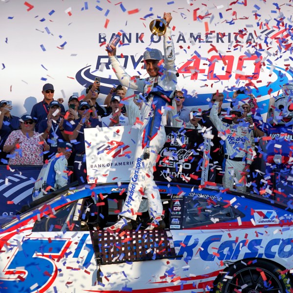 Kyle Larson, center, celebrates in Victory Lane after winning a NASCAR Cup Series auto race at Charlotte Motor Speedway in Concord, N.C., Sunday, Oct. 13, 2024. (AP Photo/Chuck Burton)