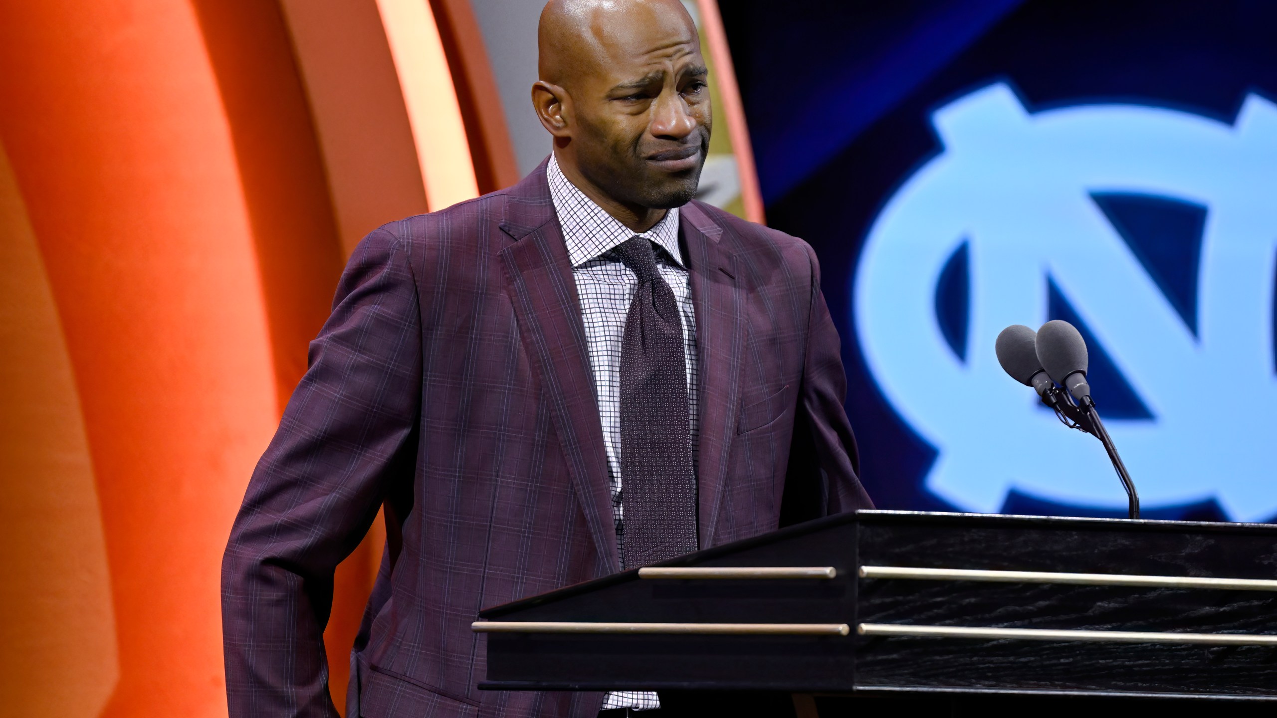 Vince Carter reacts while talking about his mother during his enshrinement in the Basketball Hall of Fame, Sunday Oct. 13, 2024, in Springfield, Mass. (AP Photo/Jessica Hill)