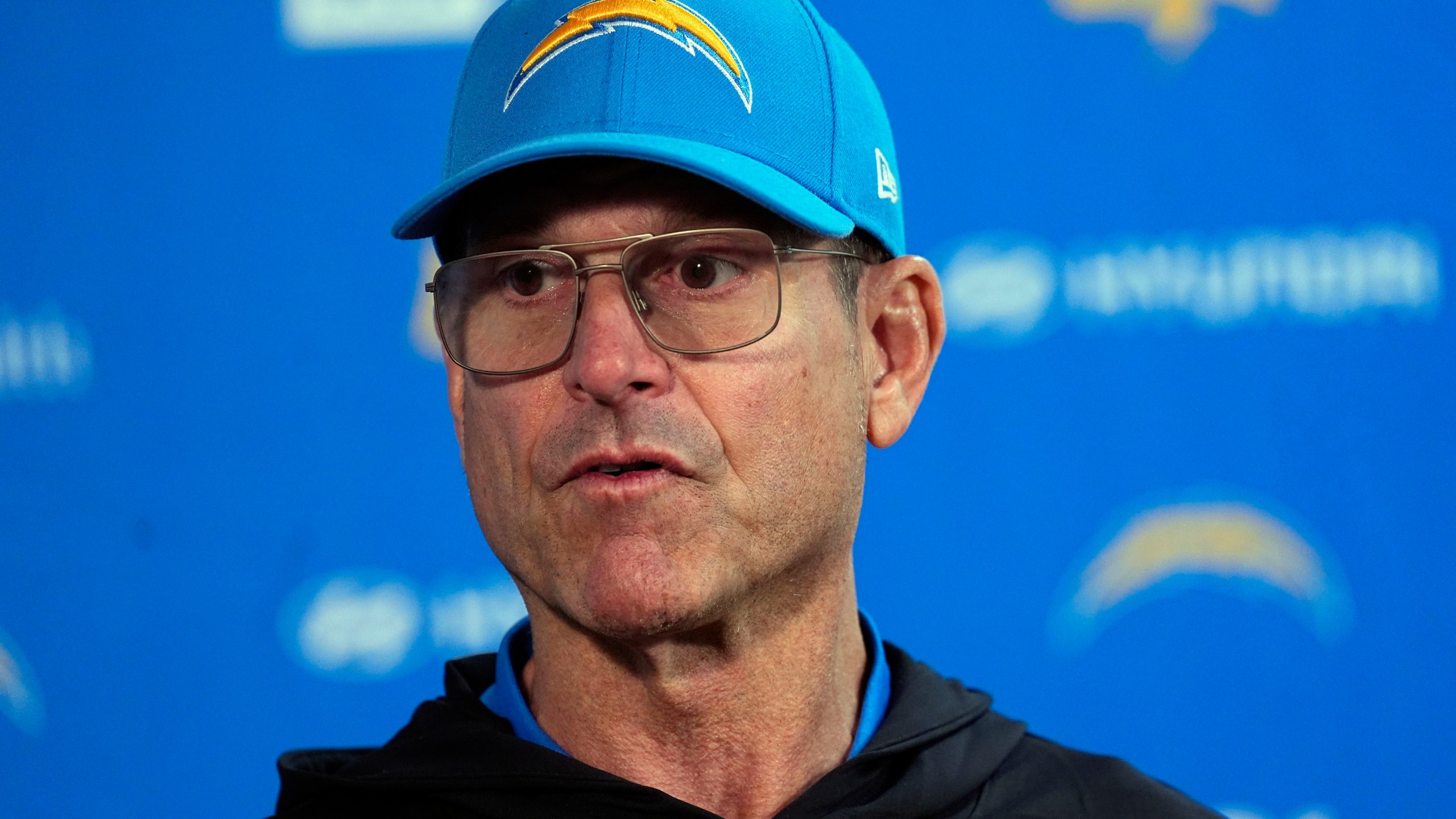 Los Angeles Chargers head coach Jim Harbaugh responds to a question during news conference after defeating the Denver Broncos in an NFL football game Sunday, Oct. 13, 2024, in Denver. (AP Photo/David Zalubowski)