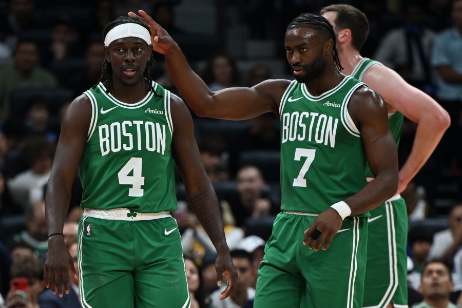 Boston Celtics Jrue Holiday, left, and Boston Celtics Jaylen Brown stand during a preseason game between Boston Celtics and Denver Nuggets in Abu Dhabi, United Arab Emirates, Friday, Oct. 4, 2024. (AP Photo/Martin Dokoupil)