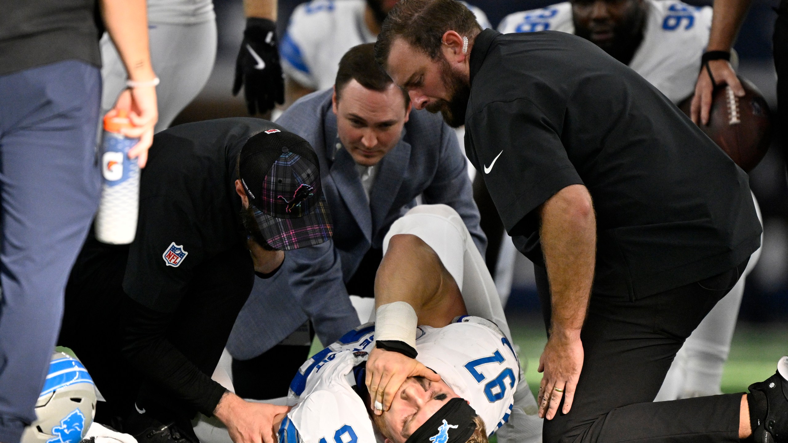 Detroit Lions defensive end Aidan Hutchinson (97) is attended to by team staff after suffering an unknown injury second half of an NFL football game against the Dallas Cowboys in Arlington, Texas, Sunday, Oct. 13, 2024. (AP Photo/Jerome Miron)