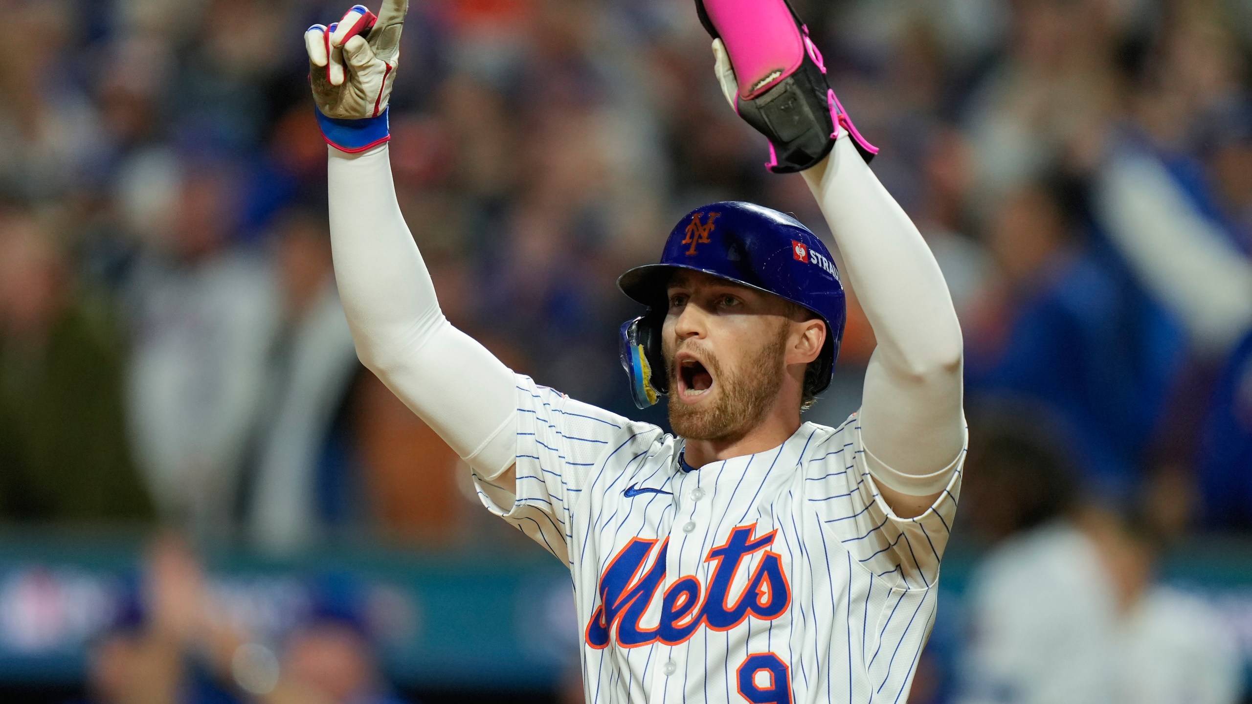 New York Mets' Brandon Nimmo (9) celebrates after scoring on a base hit by Starling Marte against the Philadelphia Phillies during the sixth inning of Game 3 of the National League baseball playoff series, Tuesday, Oct. 8, 2024, in New York. (AP Photo/Seth Wenig)