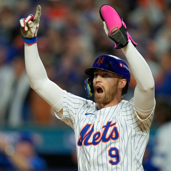 New York Mets' Brandon Nimmo (9) celebrates after scoring on a base hit by Starling Marte against the Philadelphia Phillies during the sixth inning of Game 3 of the National League baseball playoff series, Tuesday, Oct. 8, 2024, in New York. (AP Photo/Seth Wenig)