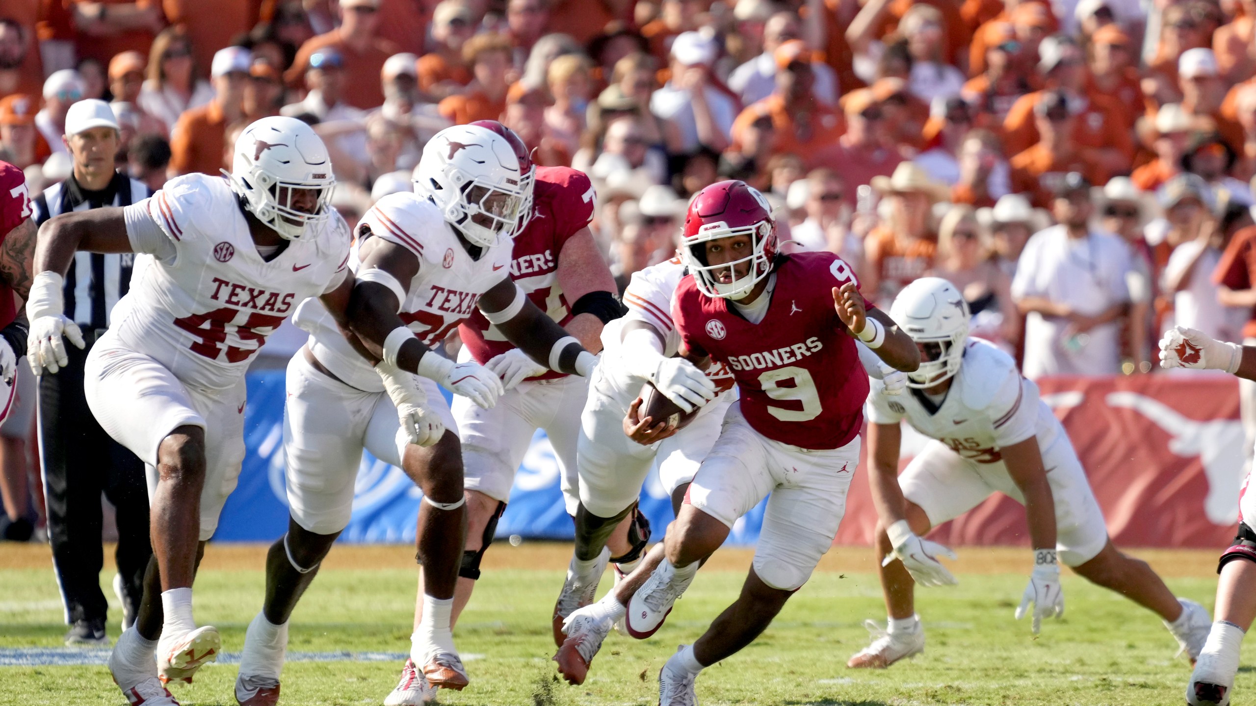 Oklahoma quarterback Michael Hawkins Jr. (9) is stripped of the ball by Texas in the second half of an NCAA college football game in Dallas, Saturday, Oct. 12, 2024. (AP Photo/Jeffrey McWhorter)