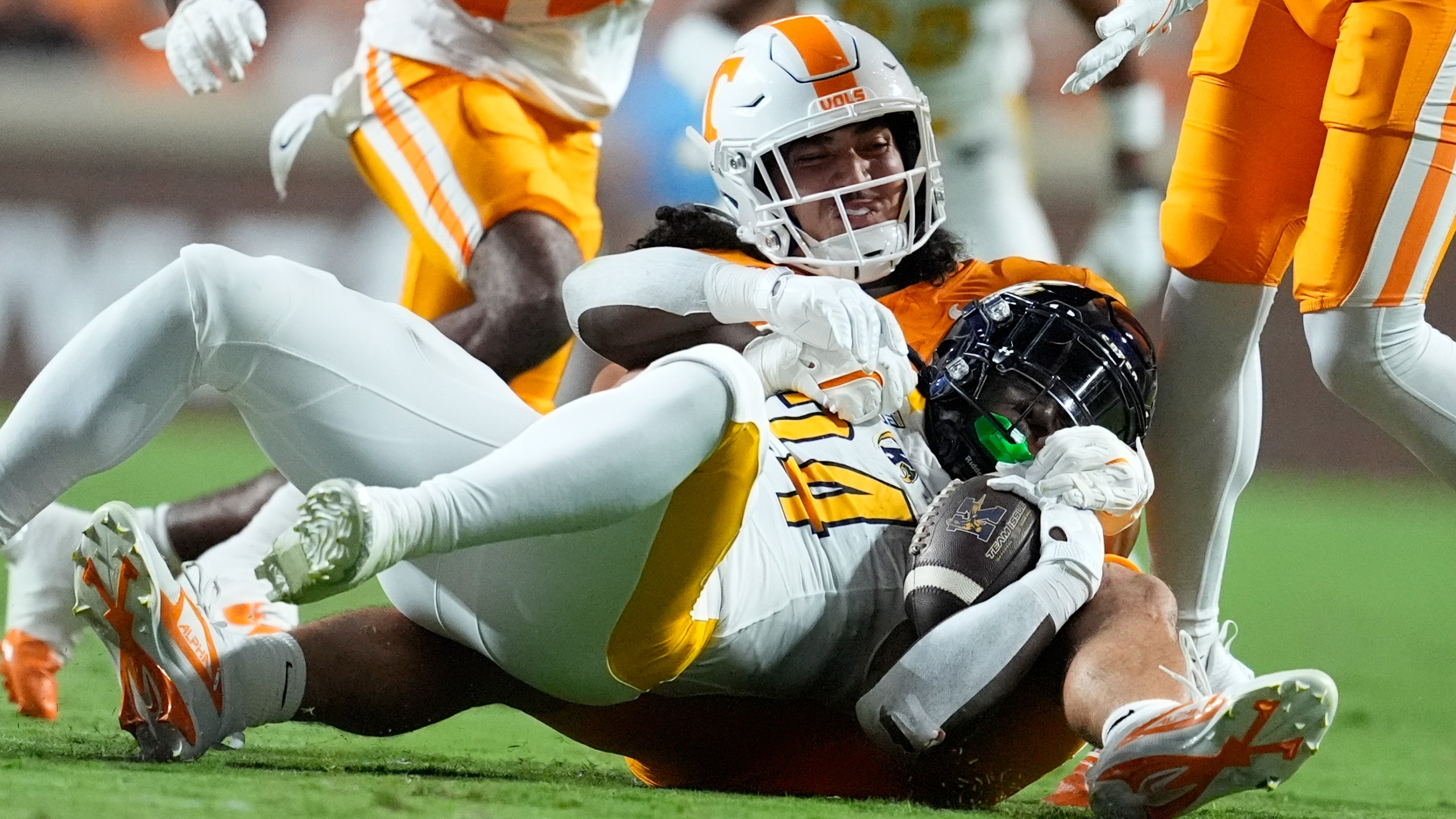 Tennessee linebacker Keenan Pili, left, tackles Kent State running back Curtis Douglas (24) during the first half of an NCAA college football game Saturday, Sept. 14, 2024, in Knoxville, Tenn. (AP Photo/George Walker IV)