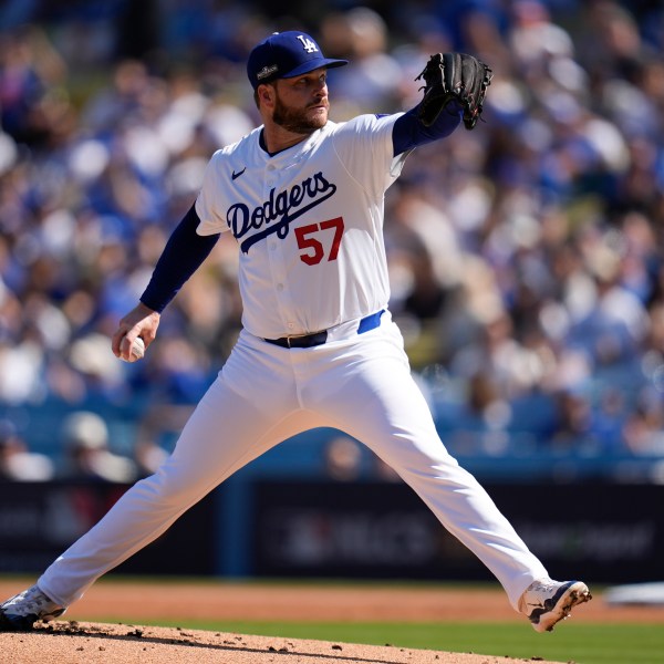 Los Angeles Dodgers pitcher Ryan Brasier throws against the New York Mets during the first inning in Game 2 of a baseball NL Championship Series, Monday, Oct. 14, 2024, in Los Angeles. (AP Photo/Gregory Bull)