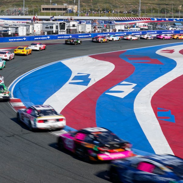 Drivers take their cars through Turn 3 during a NASCAR Cup Series auto race at Charlotte Motor Speedway in Concord, N.C., Sunday, Oct. 13, 2024. (AP Photo/Chuck Burton)