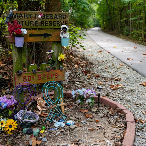 Decorated stones bearing the names of Abigail Williams and Liberty German, who were killed in February 2017, are placed at a memorial along the Monon High Bridge Trail in Delphi, Ind., Tuesday, Oct. 1, 2024. (AP Photo/Michael Conroy)