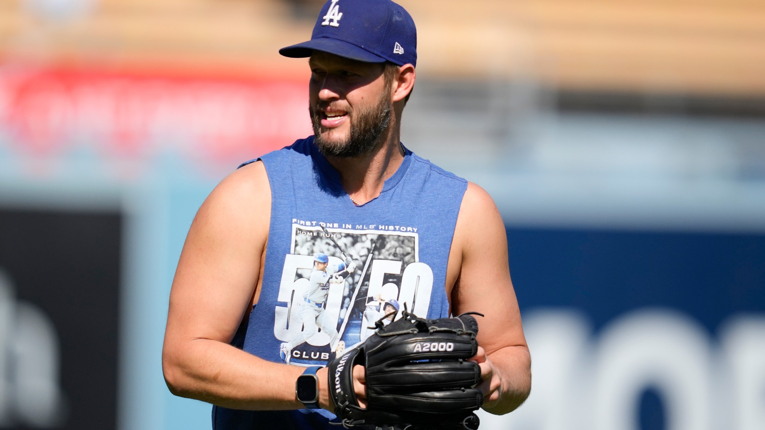 Los Angeles Dodgers pitcher Clayton Kershaw warms up before Game 2 of a baseball NL Division Series against the San Diego Padres, Sunday, Oct. 6, 2024, in Los Angeles. (AP Photo/Ashley Landis)