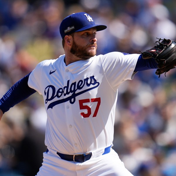 Los Angeles Dodgers pitcher Ryan Brasier throws against the New York Mets during the first inning in Game 2 of a baseball NL Championship Series, Monday, Oct. 14, 2024, in Los Angeles. (AP Photo/Gregory Bull)