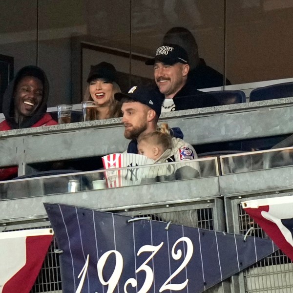 Travis Kelce, top right, and Taylor Swift watch Game 1 of the baseball AL Championship Series between the Cleveland Guardians and New York Yankees Monday, Oct. 14, 2024, in New York. (AP Photo/Frank Franklin II)