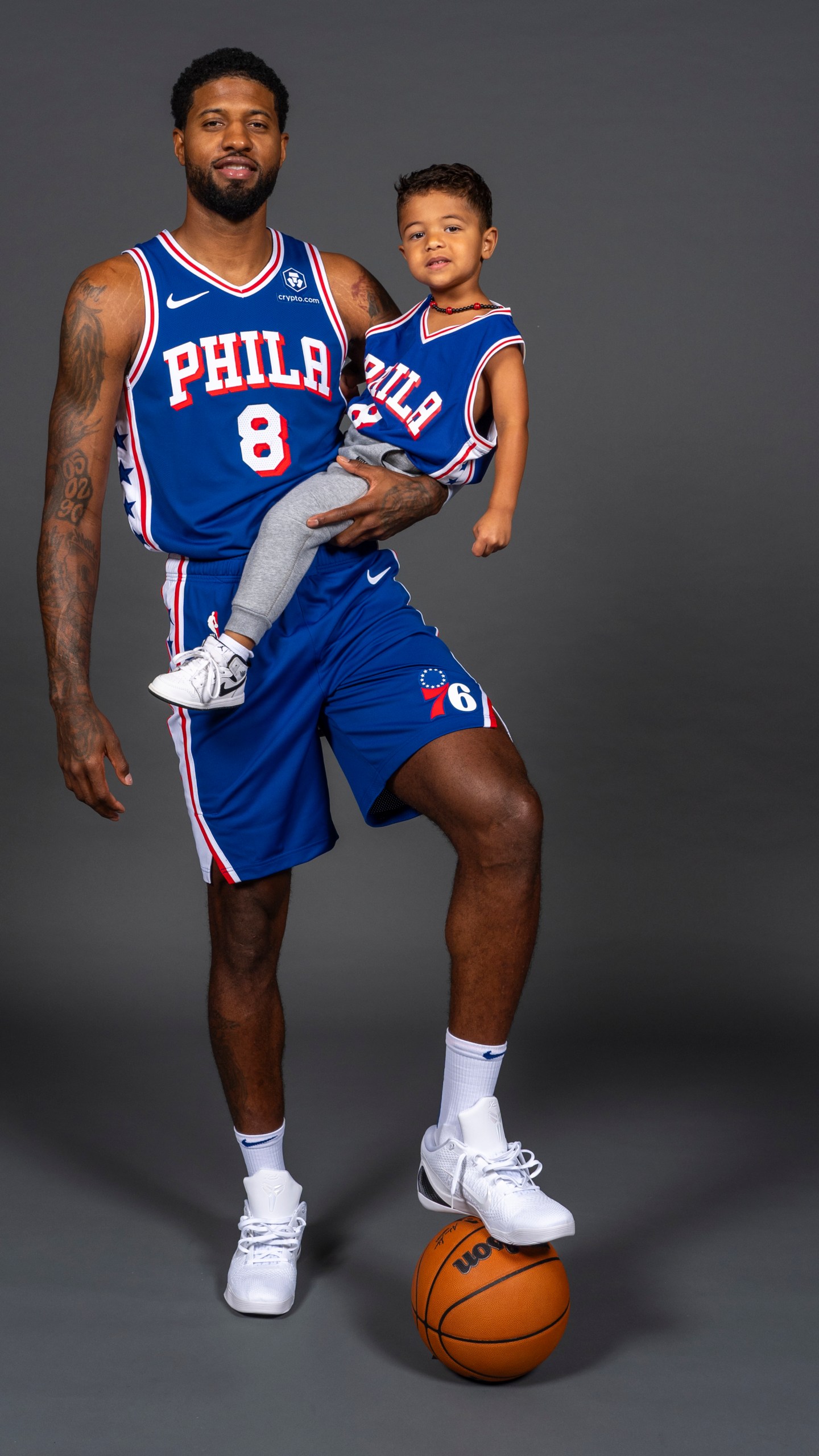 Philadelphia 76ers' Paul George poses for photos with his son, Paul, during the NBA basketball team's media day, Monday, Sept. 30, 2024, in Camden, N.J.. (AP Photo/Chris Szagola)