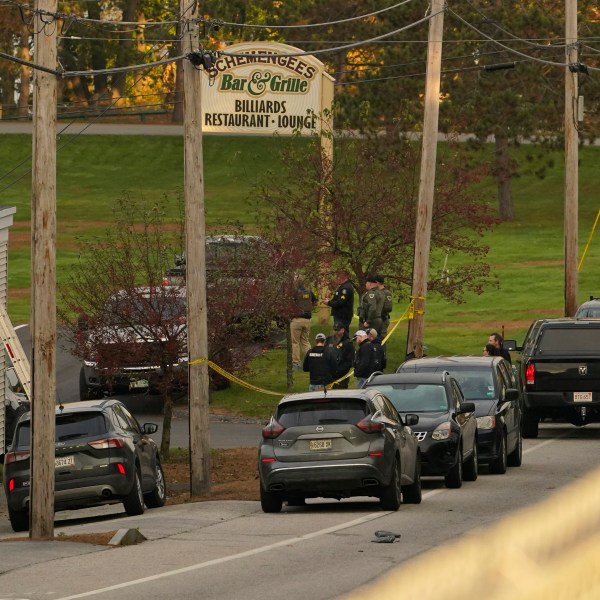 FILE - Law enforcement gather outside Schemengee's Bar and Grille, Thursday, Oct. 26, 2023, in Lewiston, Maine. (AP Photo/Robert F. Bukaty, File)