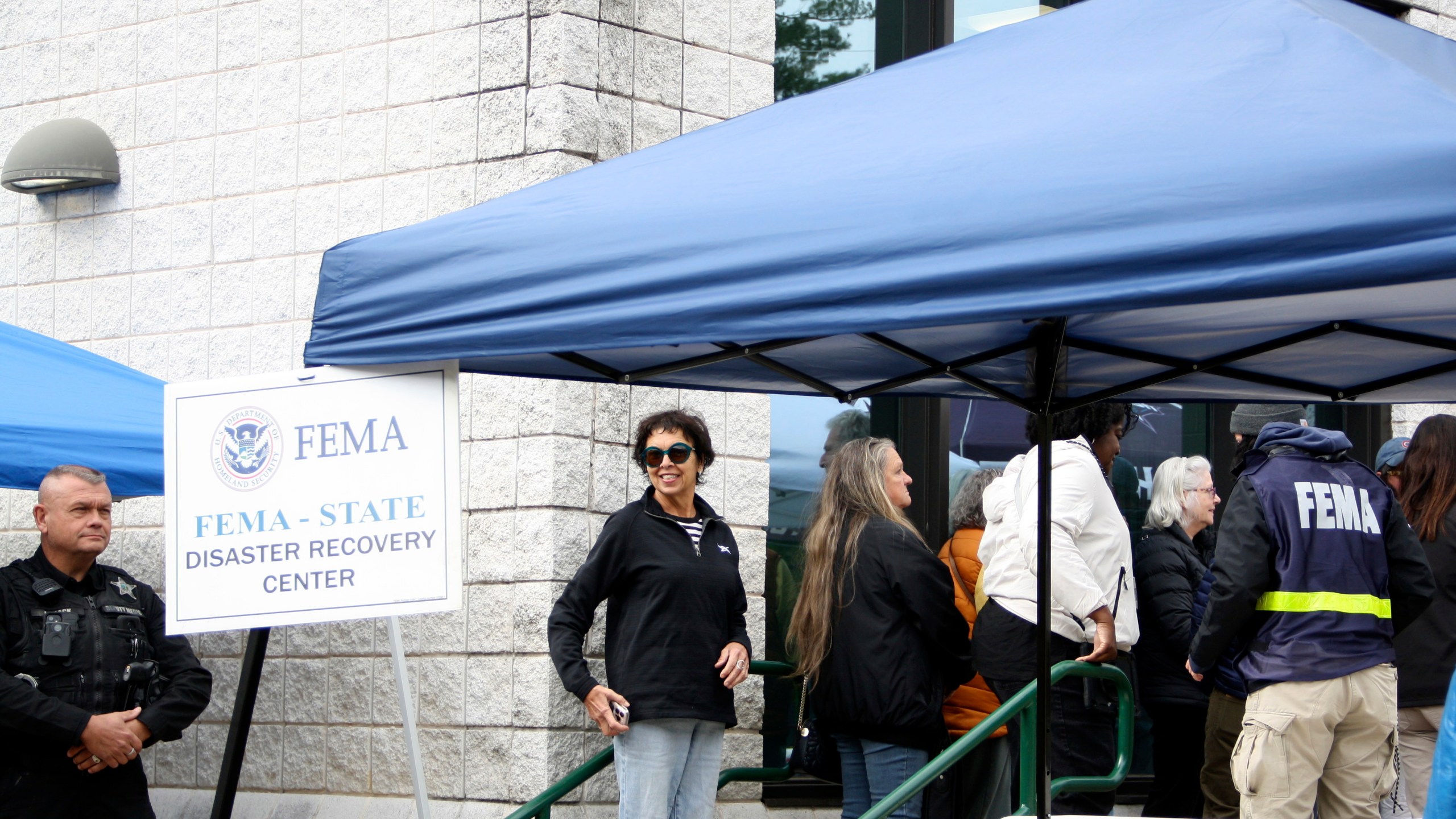 People gather at a FEMA Disaster Recovery Center at A.C. Reynolds High School in Asheville, N.C.,, Tuesday, Oct. 15, 2024. (AP Photo/Makiya Seminera)